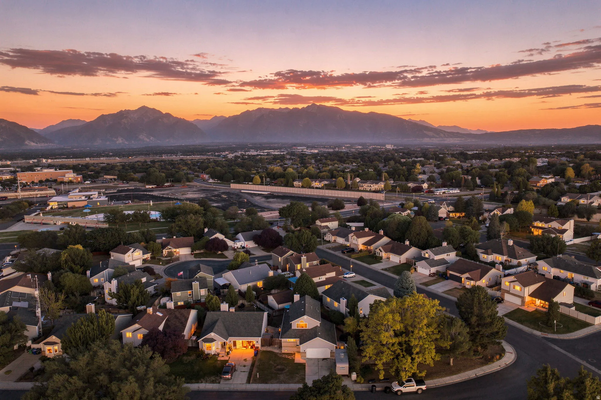 Residential neighborhood with tree-lined streets and mountain scenery