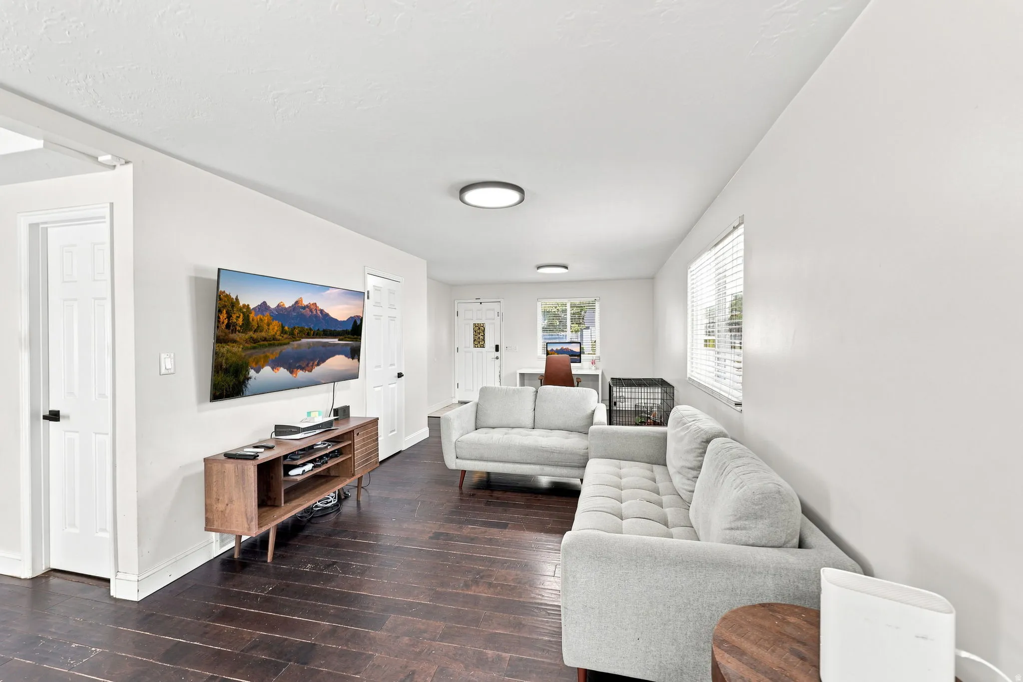 Hardwood-finish flooring, white walls, recessed lighting, white doors, and a window with blinds