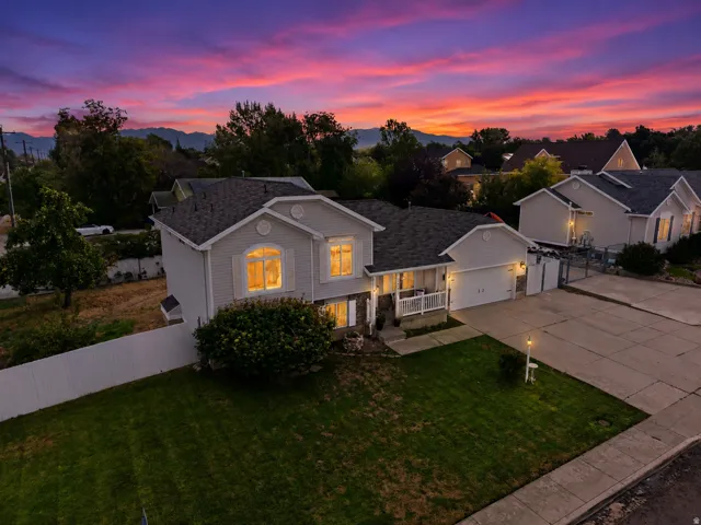 Two-story residence with light gray siding, white trim, and an attached garage
