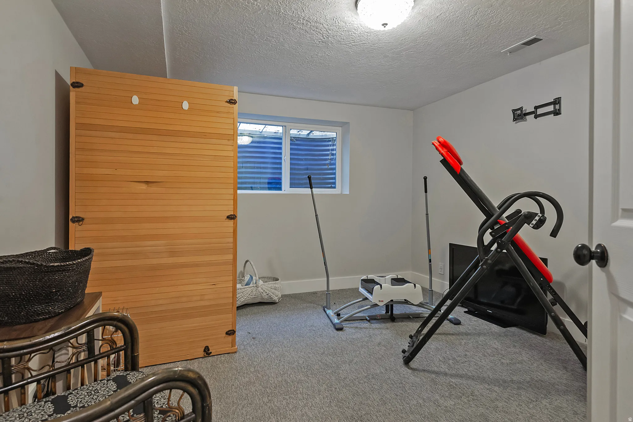 Recessed window with privacy screen, ceiling-mounted lighting, light gray wall paint, and gray carpeting