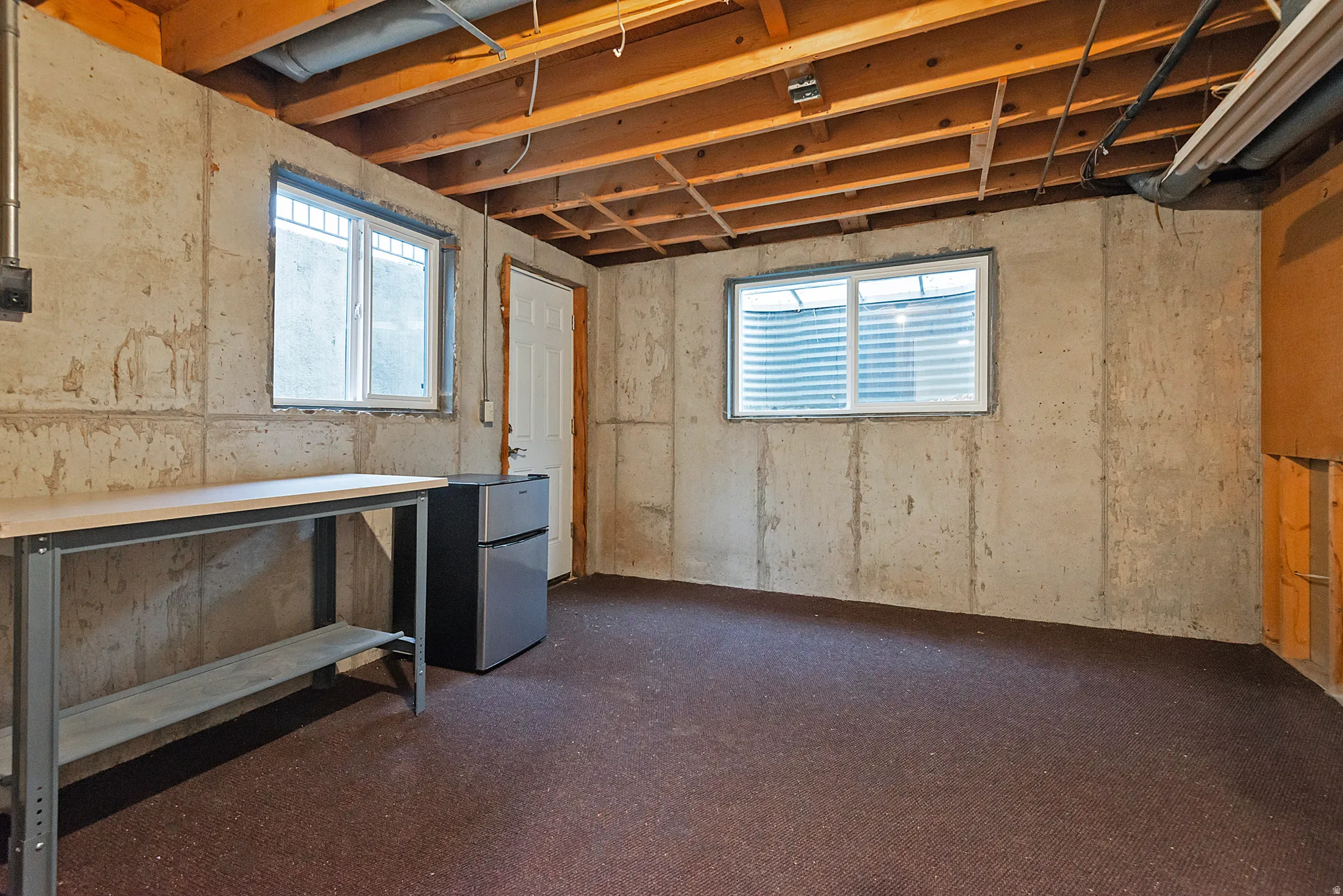 Concrete walls with exposed wood ceiling joists