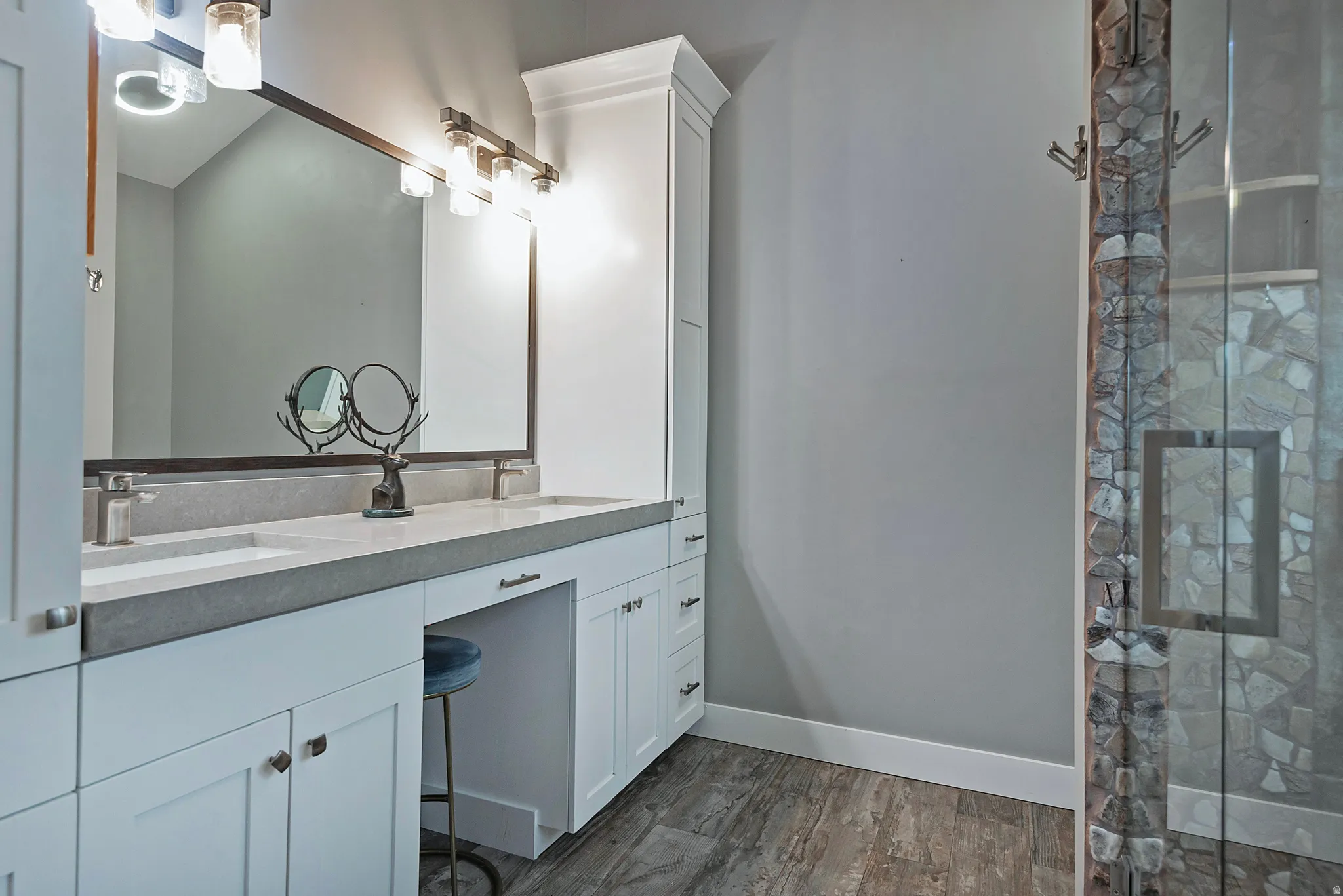 Dual vanity with undermount sinks, stone countertops, and individual faucets