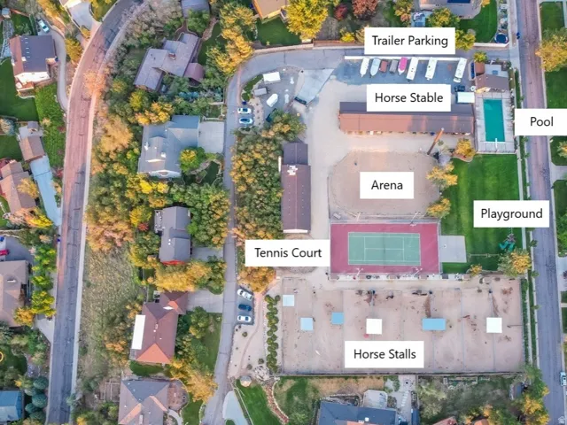 Aerial Property View. An overhead perspective highlighting the property at 10688 S Dimple Dell Dr, with surrounding structures including a tennis court, horse stalls, and a pool