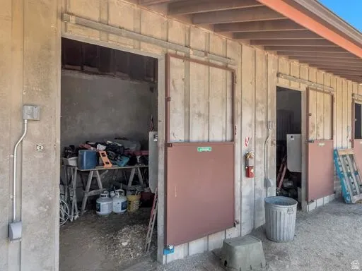 Concrete block exterior featuring multiple individual stalls with sliding metal doors