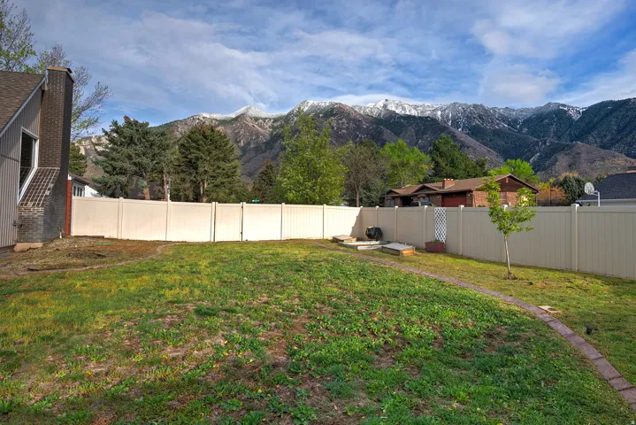 Expansive grass lawn with a full privacy fence
