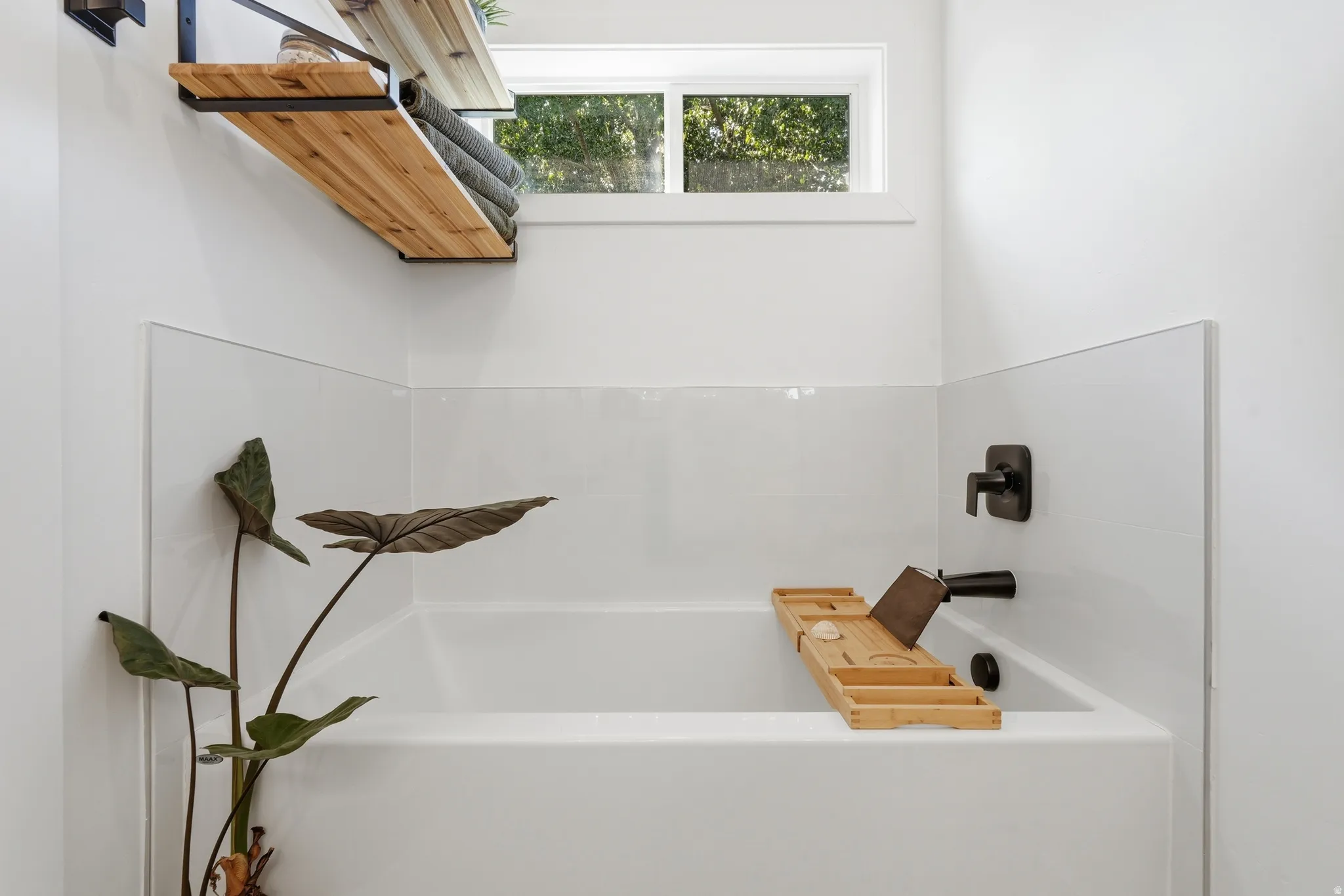 White bathtub with matte black fixtures