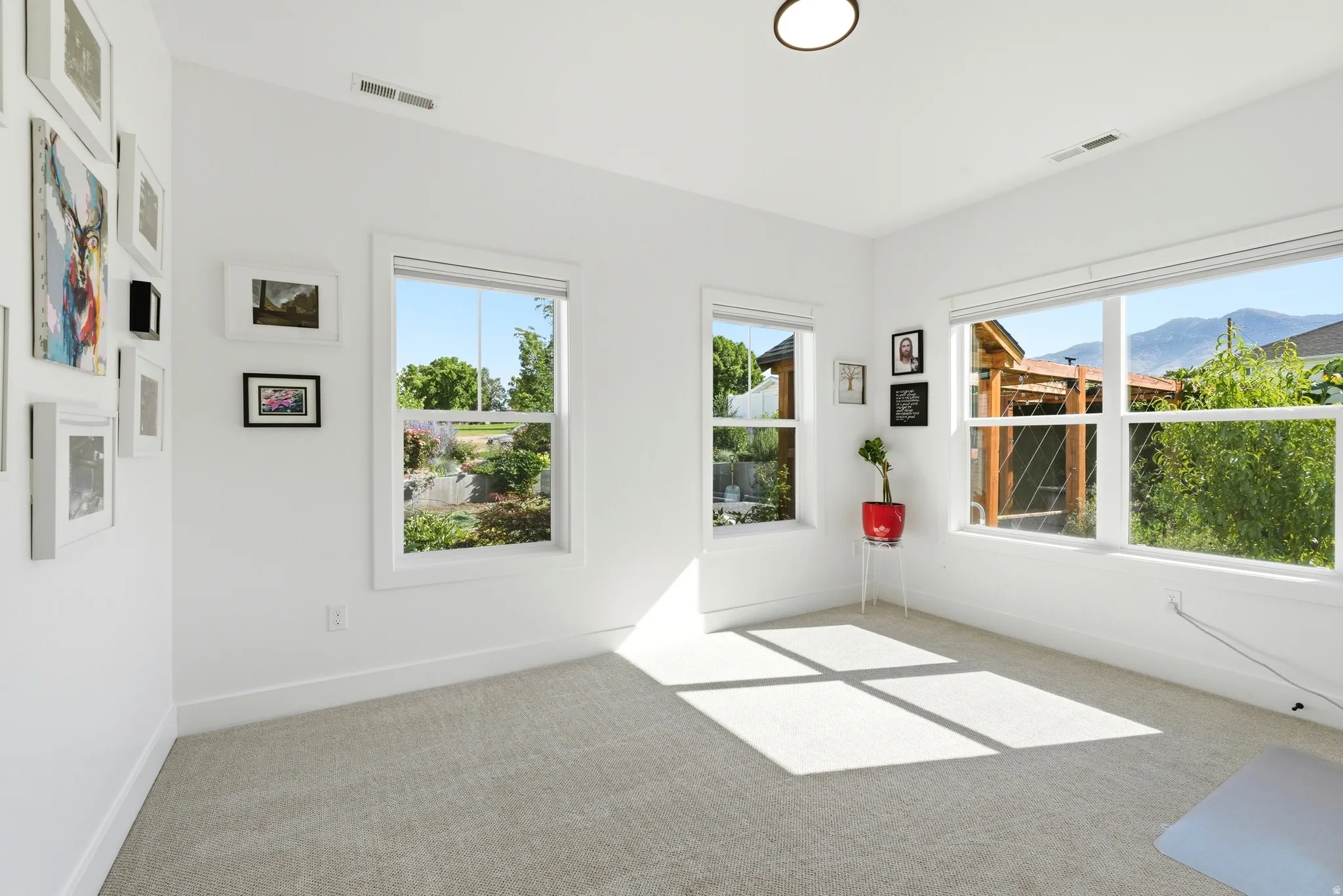 White walls with light gray carpet flooring