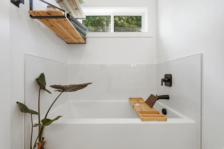 White bathtub with matte black fixtures