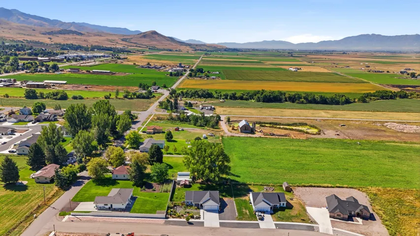Expansive rural setting featuring agricultural fields and distant mountains
