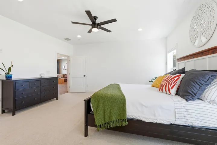 Ceiling fan with integrated lighting, recessed lighting, white walls, carpeted flooring, and a window for natural light