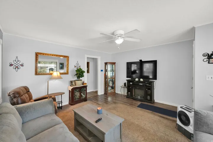 Recessed lighting, wood-finish flooring, ceiling fan, and light-toned wall paint