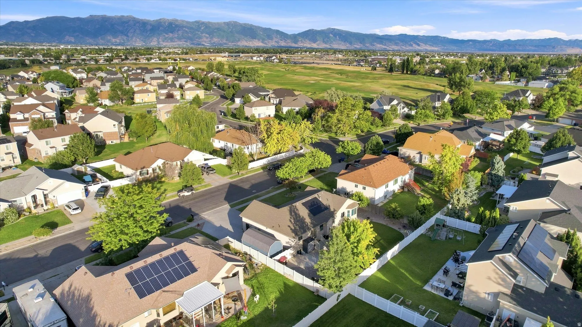 Residential neighborhood with mountain backdrop and green spaces