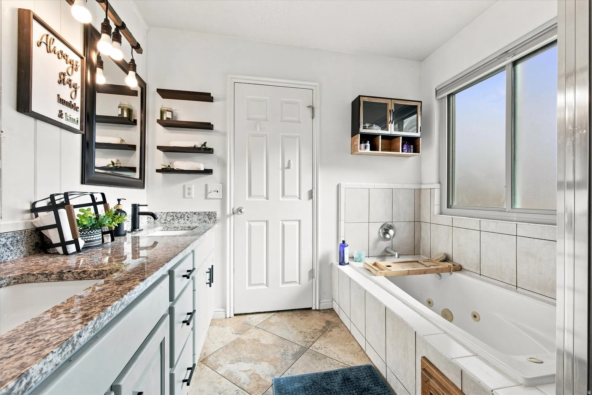 Dual vanity with granite countertops, integrated drop-in sinks, and matte black fixtures