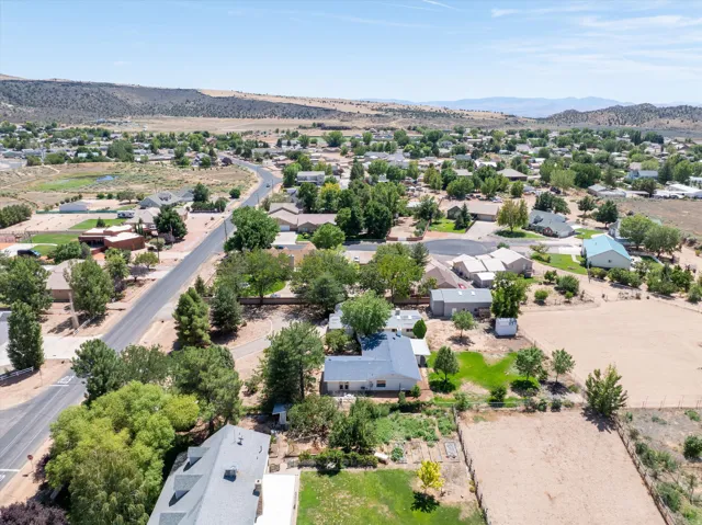 Residential community featuring varied home styles, mature landscaping, and paved roads