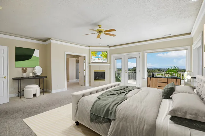 Carpeted flooring, corner fireplace with mantel, ceiling fan, double French doors, and expansive windows