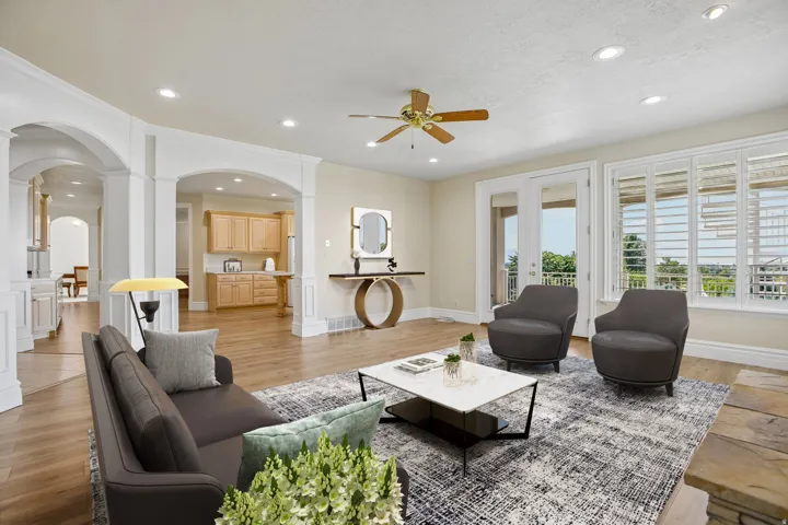 Recessed lighting, wood-finish flooring, and arched doorways define this living space