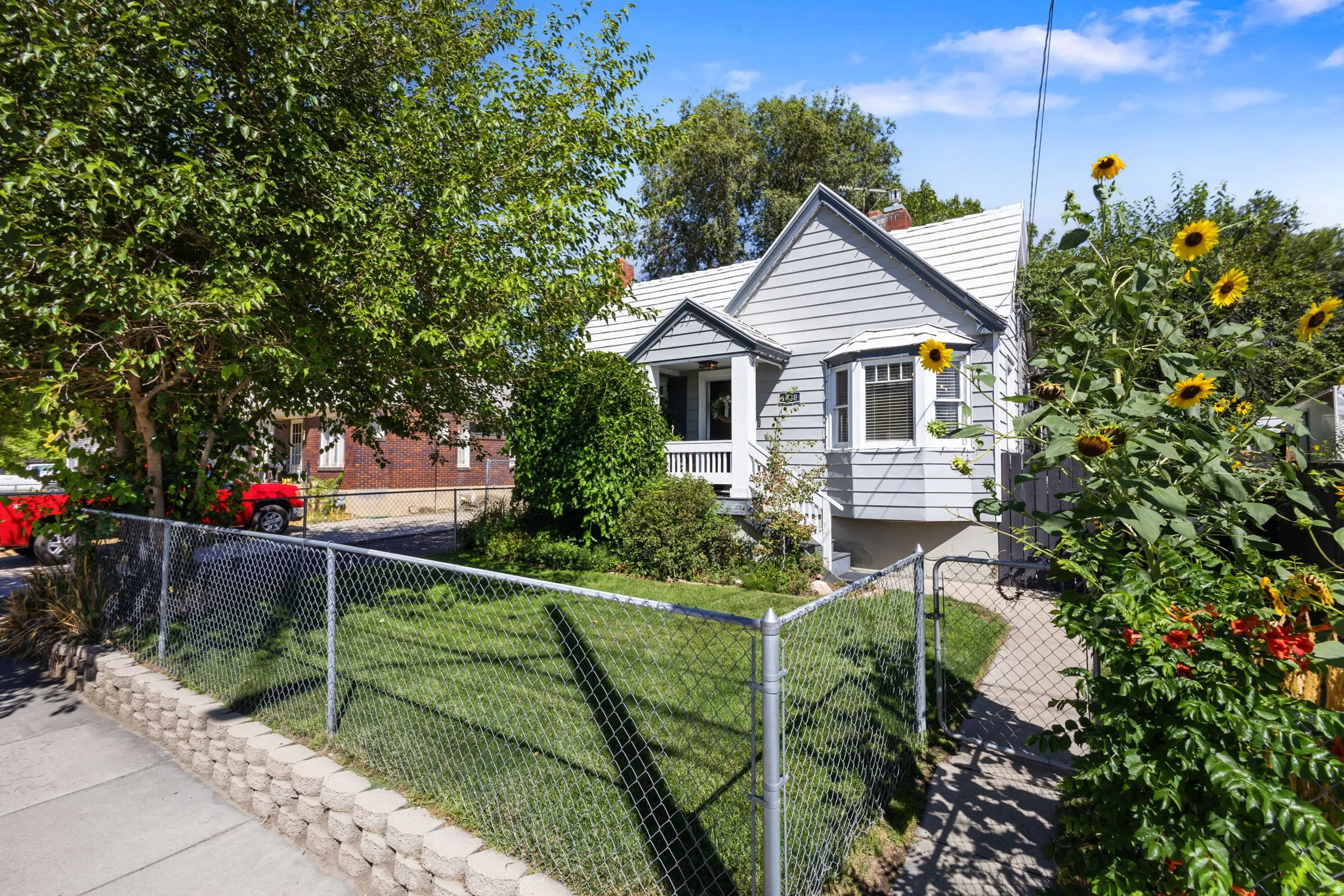 Exterior with white trim and a covered porch