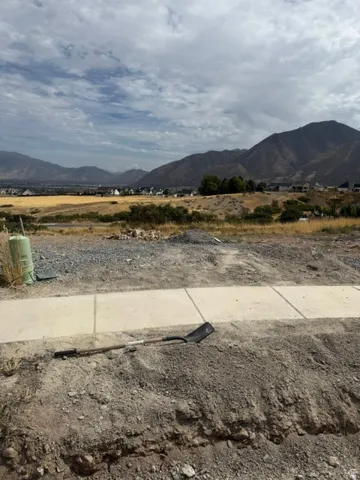 Mountain backdrop with residential structures in the distance