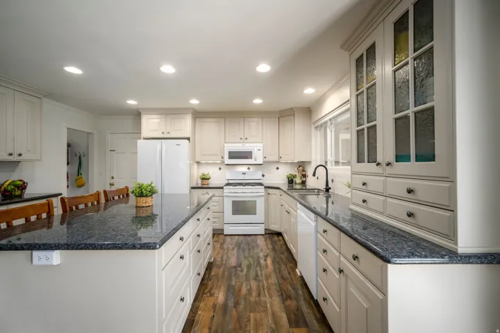 Wood-finish flooring, recessed lighting, and cabinetry and Island
