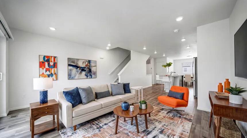 Expansive open-concept living area featuring recessed lighting, wood-finish flooring, and white walls