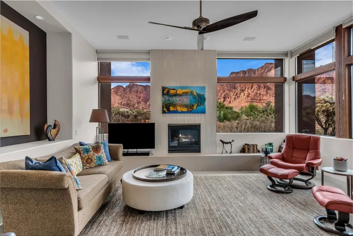 Living Room with gas fireplace, views of the Kayenta Cliffs, waterfalls, and Hellhole Canyon