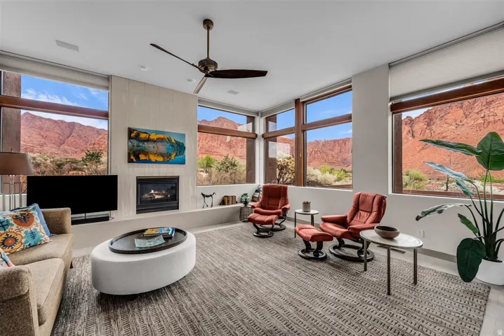 Living Room with gas fireplace, views of the Kayenta Cliffs, waterfalls, and Hellhole Canyon
