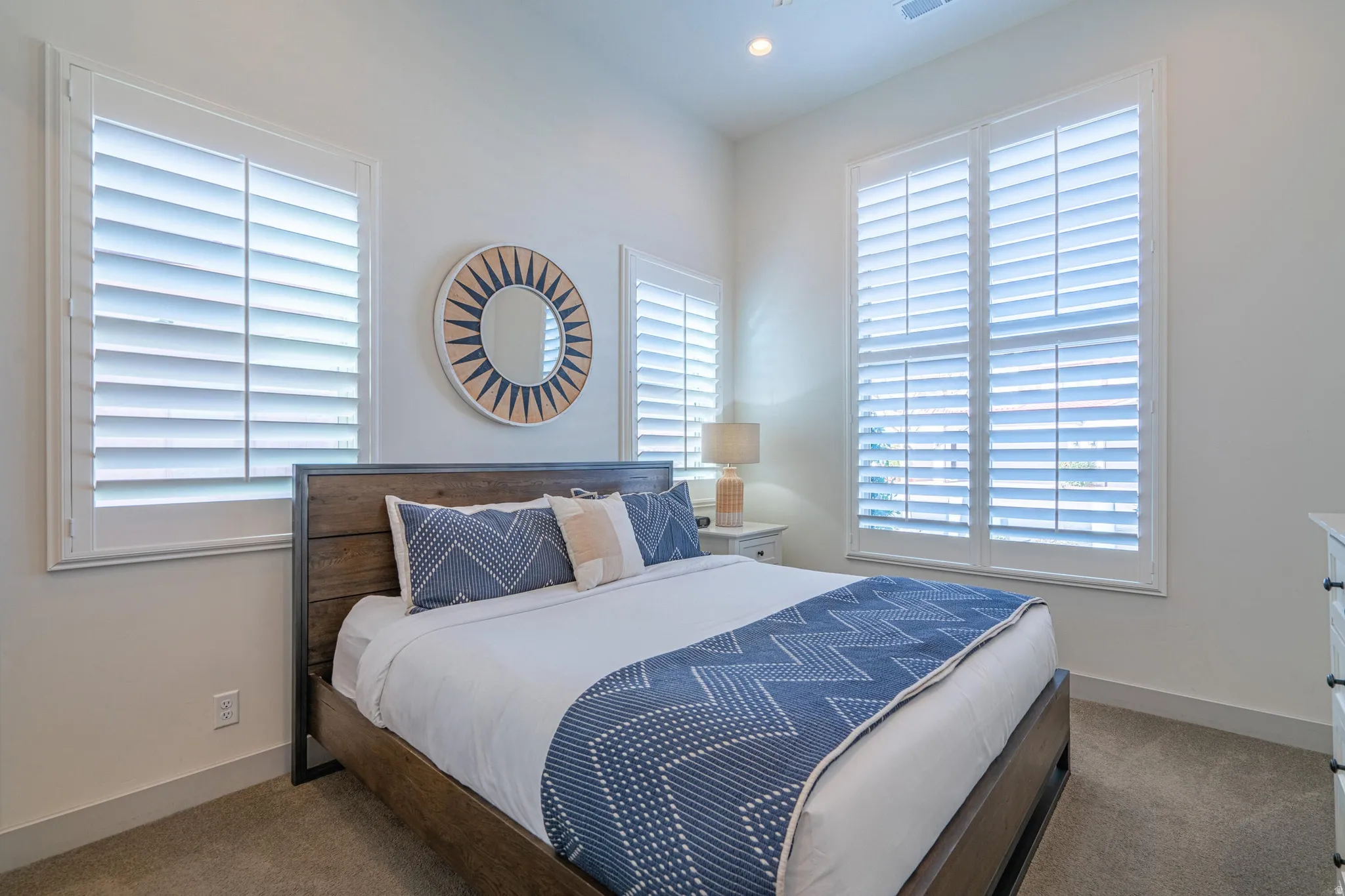 Main Floor Bedroom 2, Recessed lighting, light-colored walls, plantation shutters, and carpeted flooring