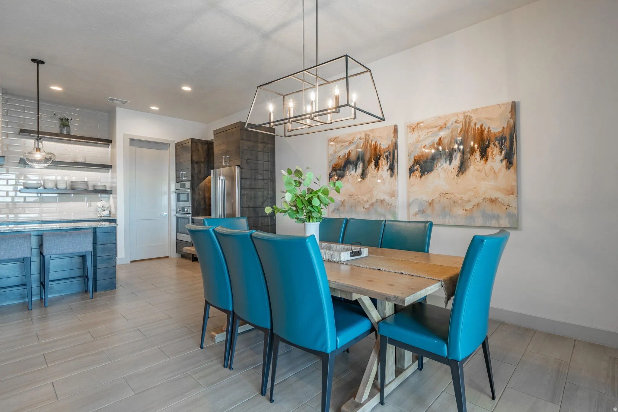 Recessed lighting, wood-finish flooring and a linear chandelier