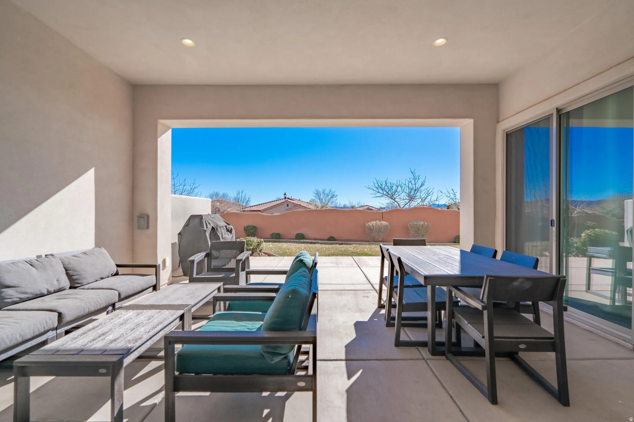 Covered patio featuring recessed lighting, concrete flooring, and an open outdoor area