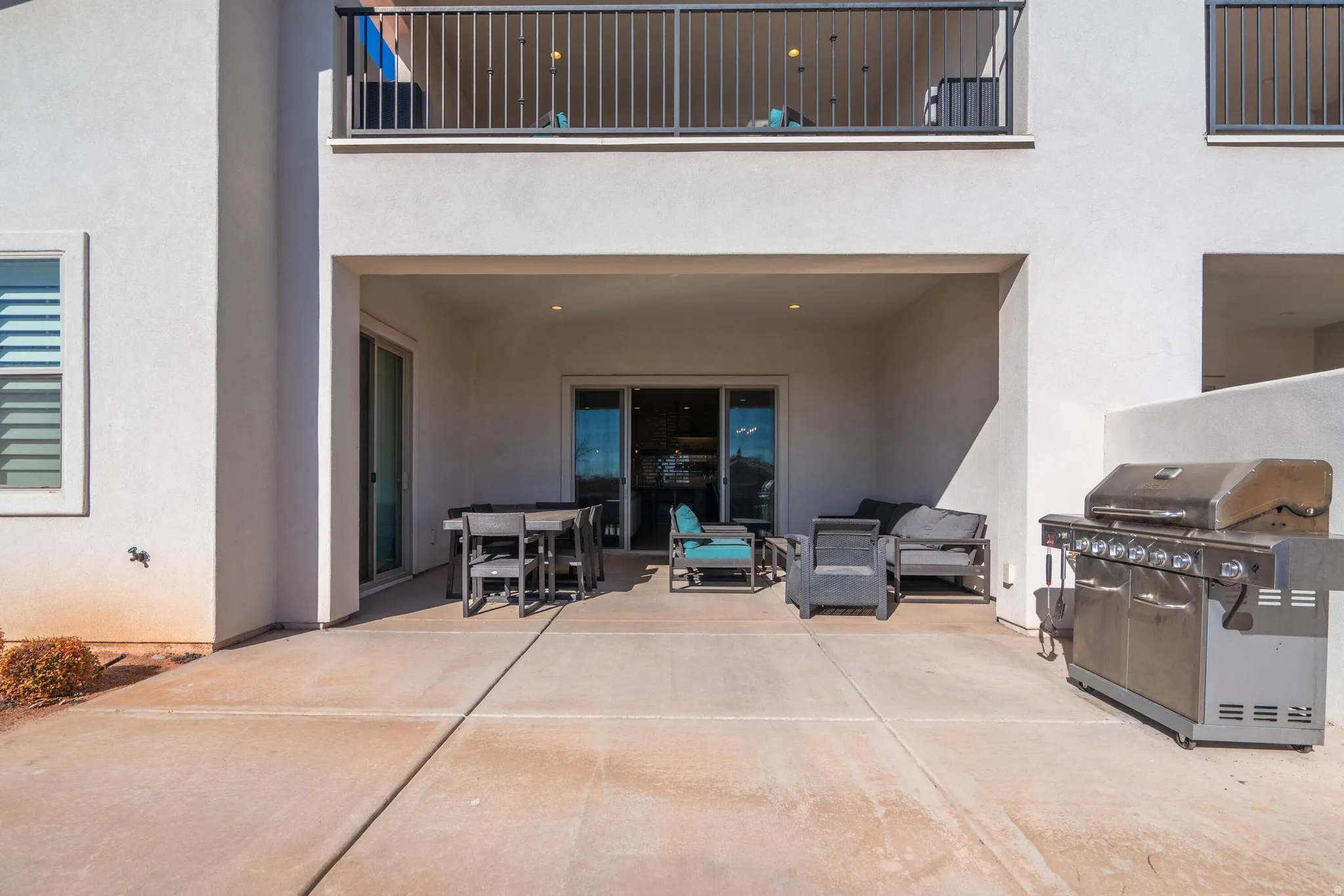 Covered patio with recessed lighting, concrete flooring, and sliding glass doors