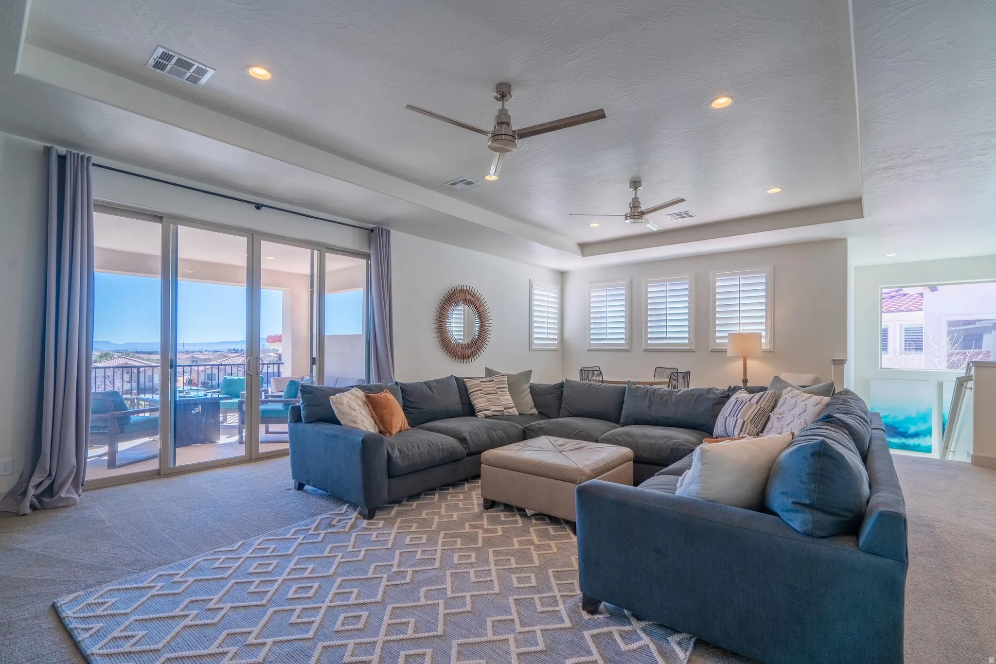 2nd Floor Family Room with recessed lighting, tray ceiling, two ceiling fans, sliding glass doors, and carpet flooring