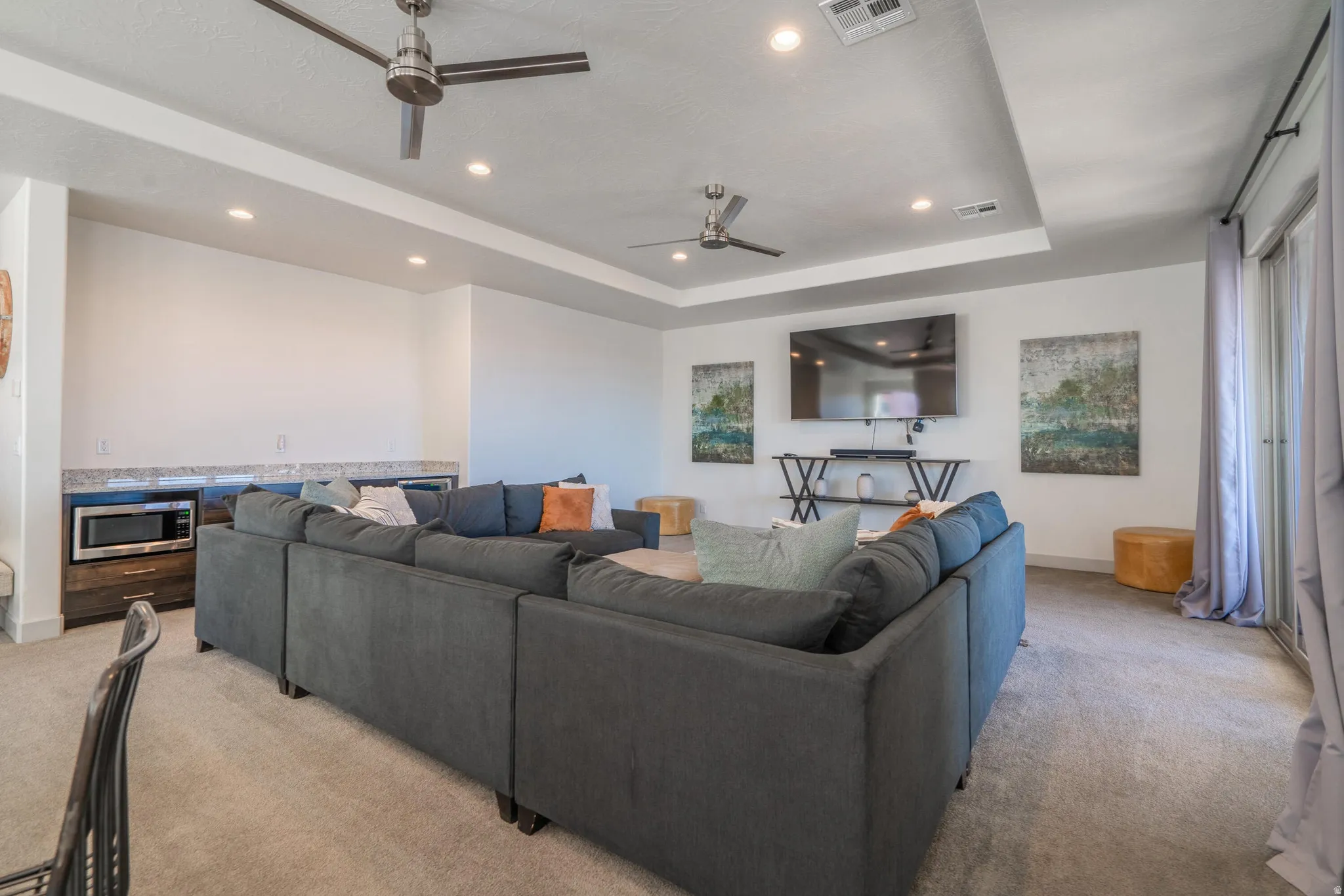 2nd Floor Family Room with recessed lighting, tray ceiling, two ceiling fans, sliding glass doors, and carpet flooring