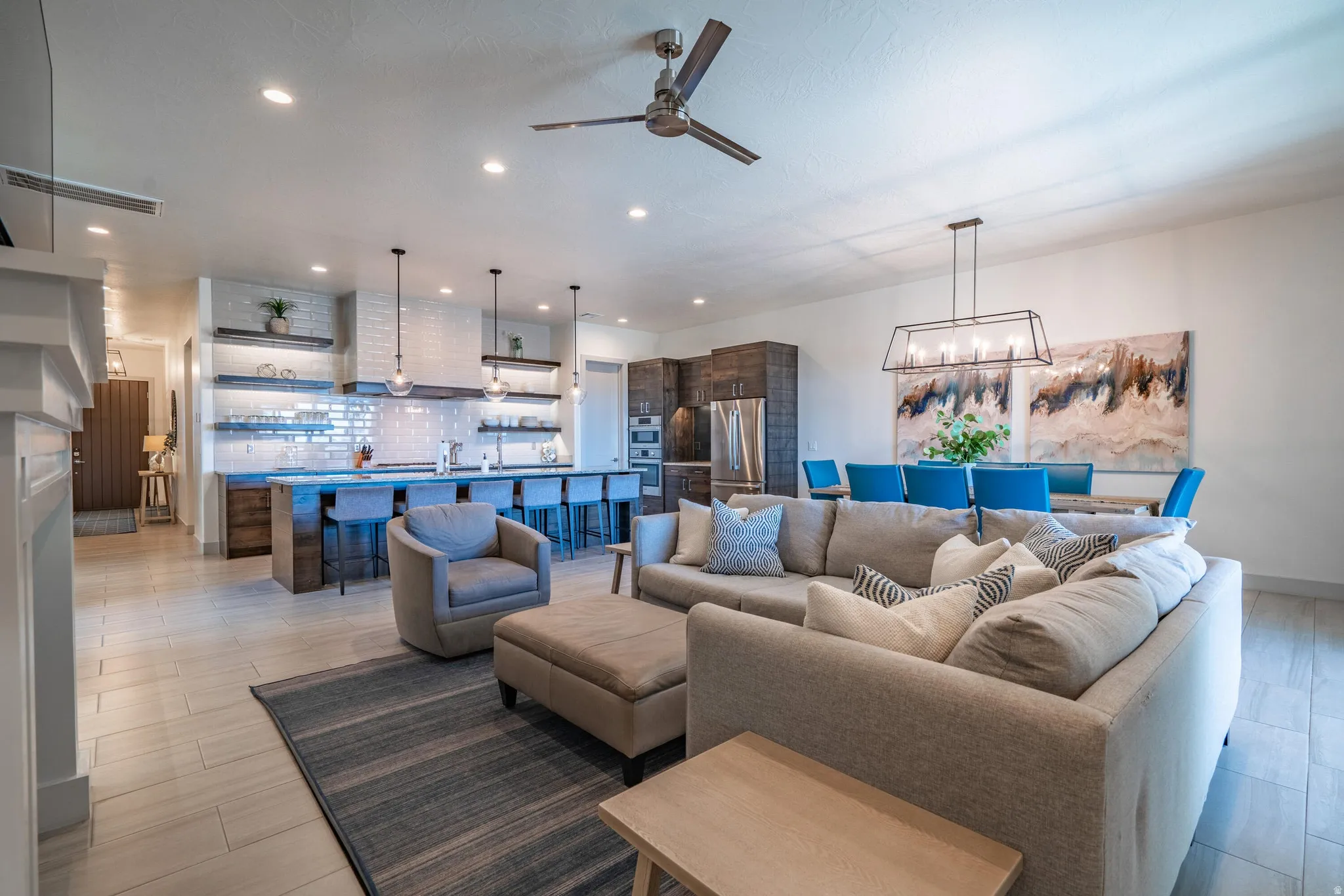 Open-concept living space featuring wood-finish flooring, recessed lighting, and a ceiling fan