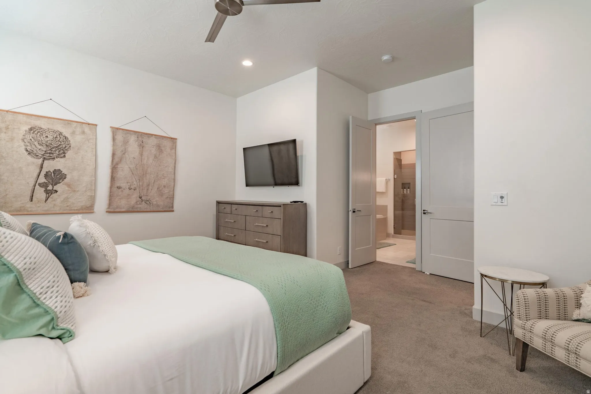 Main Floor Primary Bedroom with recessed lighting, ceiling fan, light carpet flooring and light-colored walls