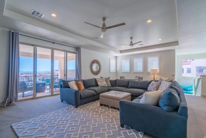 2nd Floor Family Room with recessed lighting, tray ceiling, two ceiling fans, sliding glass doors, and carpet flooring