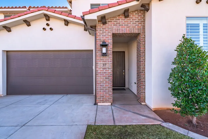 Stucco exterior with brick accents and red roof tiles