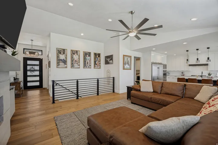 Open-concept living space featuring wood flooring, recessed lighting, and a modern ceiling fan