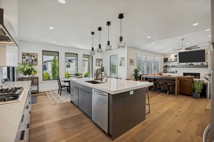 Expansive kitchen island with an integrated sink and pendant lighting