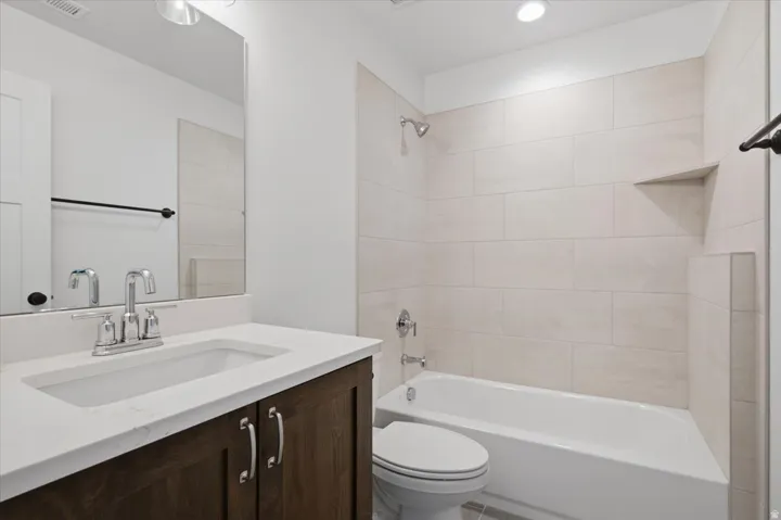 Dark wood-finish vanity with a white countertop and undermount sink
