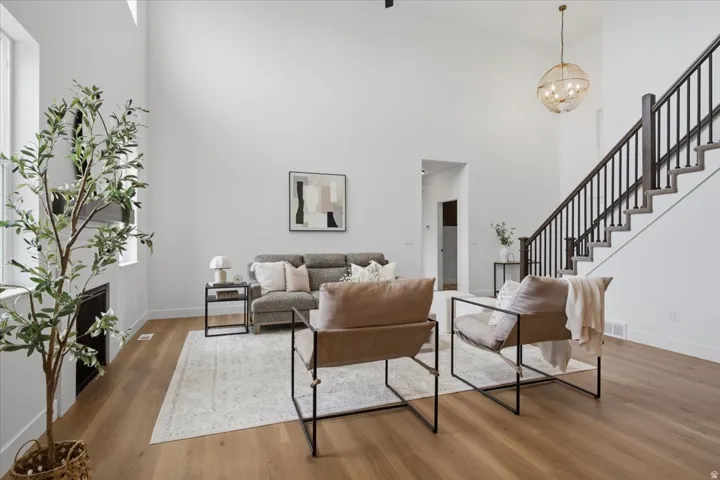 Vaulted ceilings with an open-tread staircase featuring dark wood and black metal balusters