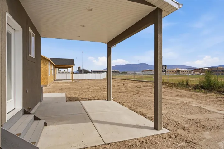 Covered patio with recessed lighting and concrete flooring