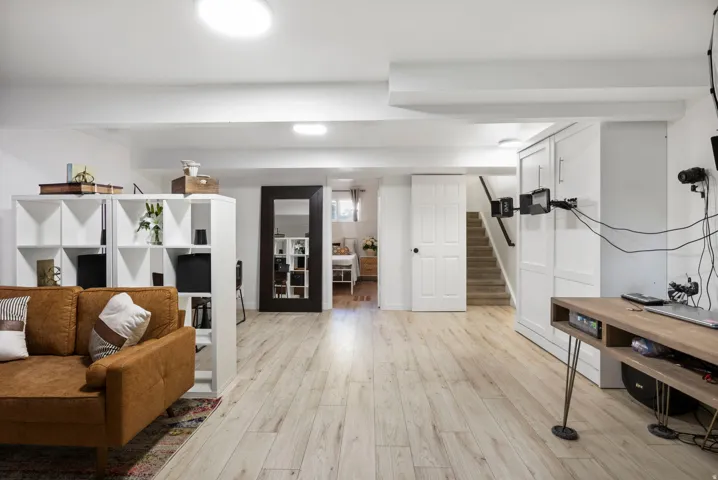 Light-tone wood-finish flooring extends throughout the space