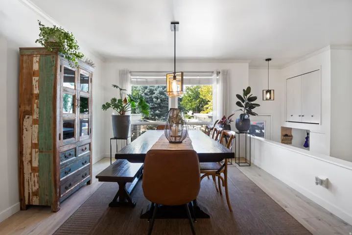 Recessed wall storage, light-colored flooring, window with exterior foliage, and pendant lighting