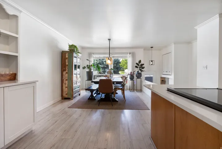 Light wood-finish flooring extends through the space
