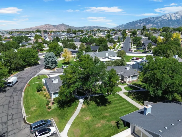 Expansive residential setting with mature trees and mountain backdrops