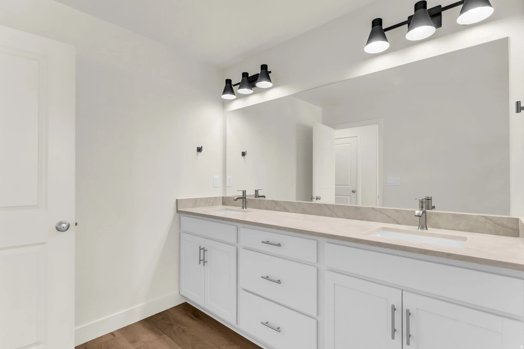 Dual vanity with white cabinetry and brushed nickel hardware