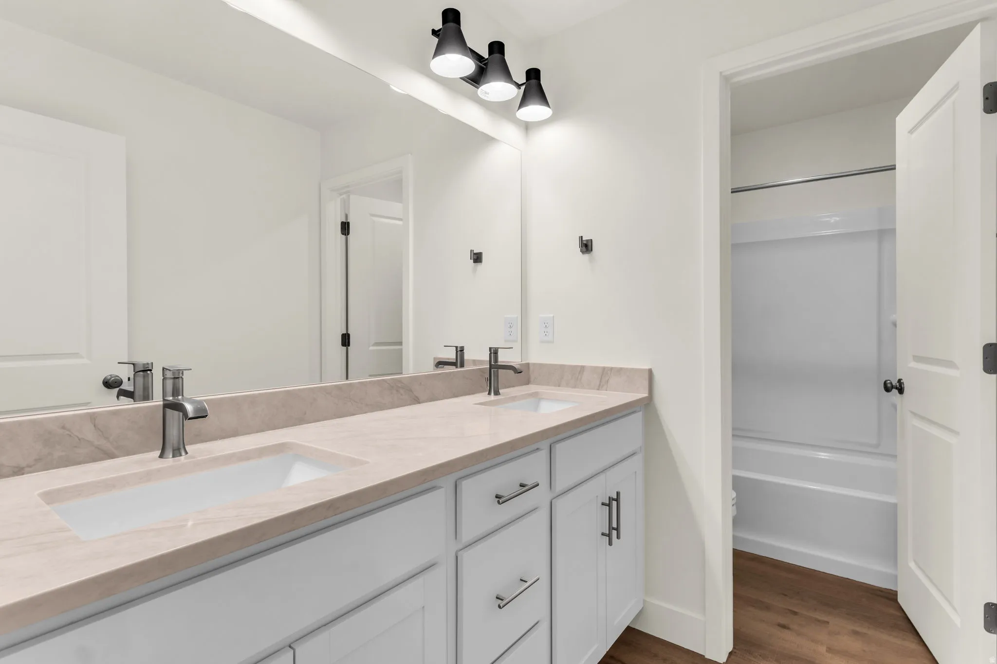 Dual vanity with undermount sinks, stone-finish countertop, and dark-finish hardware