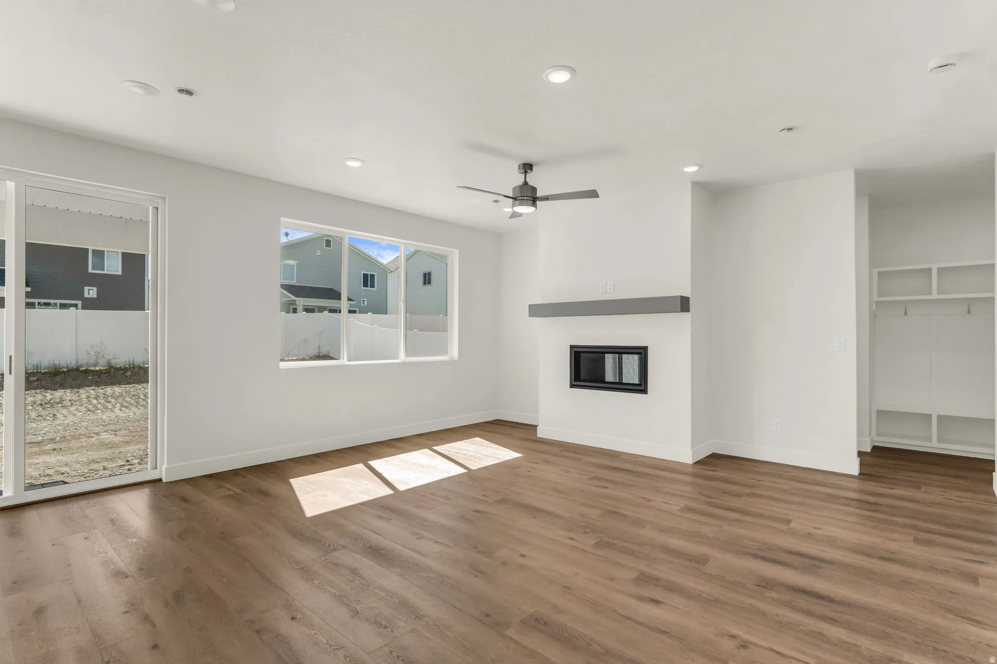 Wood-finish flooring throughout, recessed lighting, and a ceiling fan