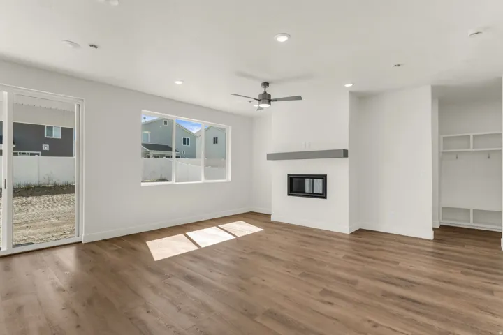 Wood-finish flooring throughout, recessed lighting, and a ceiling fan