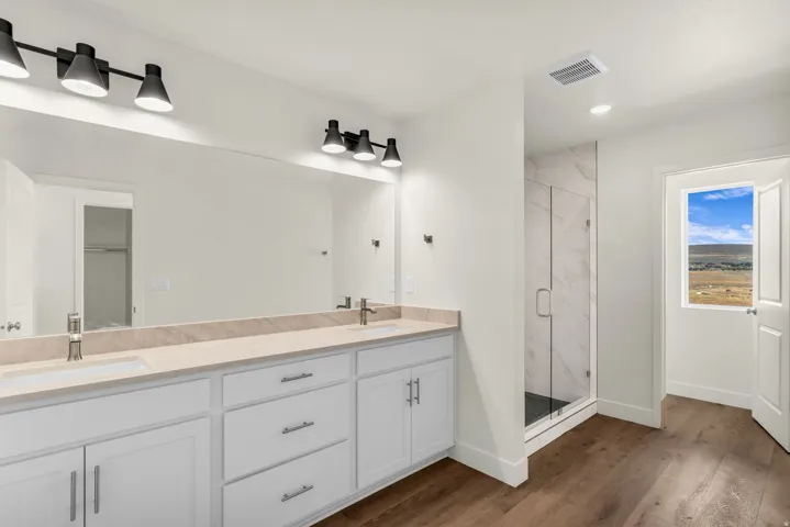 Dual vanity with light-toned countertops and undermount sinks